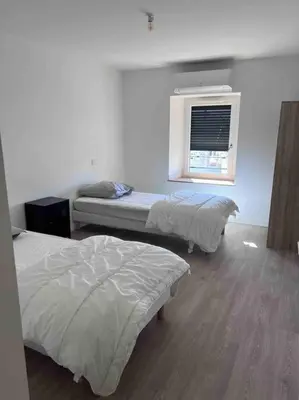Un ou plusieurs lits dans un hébergement de l'établissement Gîte Anna