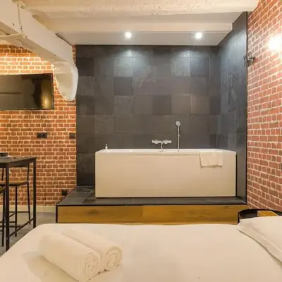 Industrial-style studio with bathtub