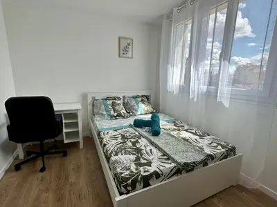 Un ou plusieurs lits dans un hébergement de l'établissement Appartement 3 chambres - Proche metro