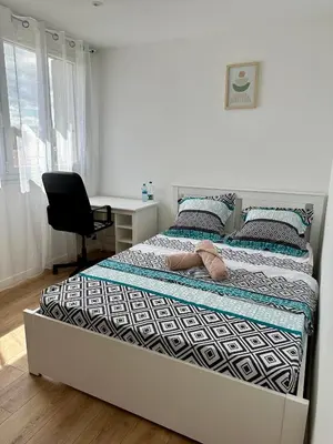 Un ou plusieurs lits dans un hébergement de l'établissement Appartement 3 chambres - Proche metro