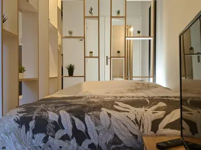 Un ou plusieurs lits dans un hébergement de l'établissement Logement charmant Charpennes