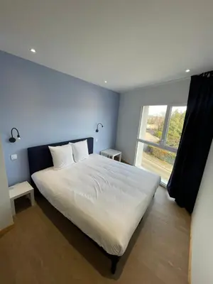 Un ou plusieurs lits dans un hébergement de l'établissement LE SALVADOR - Appart'Hôtel de 18m2 à 44m2