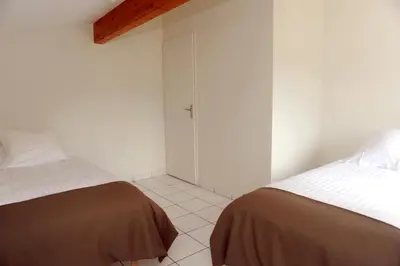 Un ou plusieurs lits dans un hébergement de l'établissement A la Suite du Jardin de l'Isle