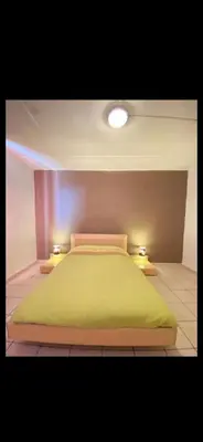 Un ou plusieurs lits dans un hébergement de l'établissement Belle appartement chaleureux à 2 mn à pied du tramway.