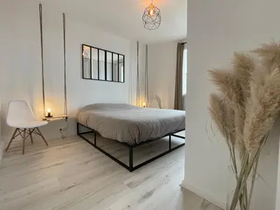 Un ou plusieurs lits dans un hébergement de l'établissement Logement chaleureux et lumineux