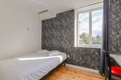 Un ou plusieurs lits dans un hébergement de l'établissement Le Hamburg - Les appartements de l'olivier