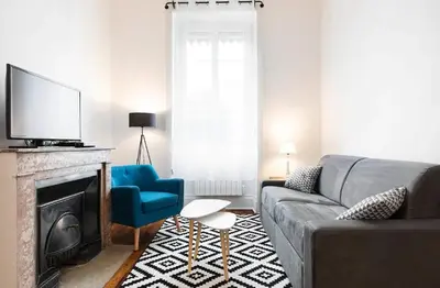 Coin salon dans l'établissement appartement 2 pièces Jean Macé et stationnement
