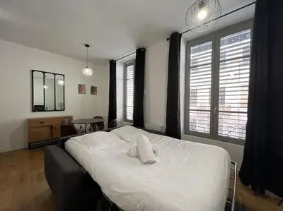 Un ou plusieurs lits dans un hébergement de l'établissement Studio chaleureux, proche gare, Lyon 3
