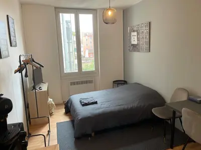 Un ou plusieurs lits dans un hébergement de l'établissement Studio Hôtel Villeurbanne Centre
