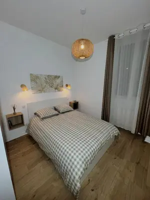 Un ou plusieurs lits dans un hébergement de l'établissement appartement cosy