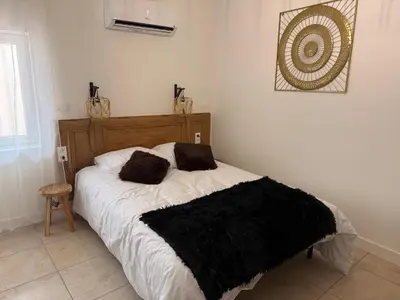 Un ou plusieurs lits dans un hébergement de l'établissement Saint Amour Appartement T2