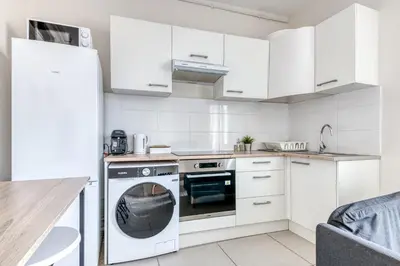 Cuisine ou kitchenette dans l'établissement T3 L'Étoile NEUF Cosy & Lumineux - Gare Parilly