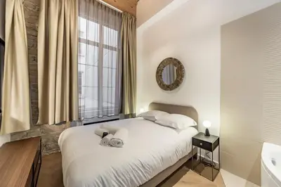 Un ou plusieurs lits dans un hébergement de l'établissement Cosy Opéra - Studio avec Balnéo et clim à Lyon