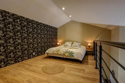 Un ou plusieurs lits dans un hébergement de l'établissement Duplex avec terrasse proche Pérouges Meximieux CNPE BUGEY