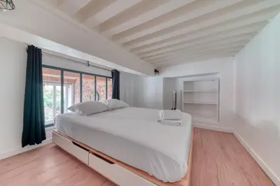 Un ou plusieurs lits dans un hébergement de l'établissement Le Pouteau charme authentique 2 chambres