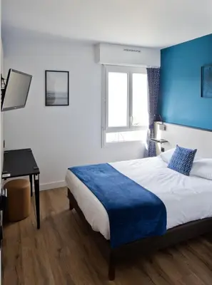 Un ou plusieurs lits dans un hébergement de l'établissement Hôtel Le Riccoty