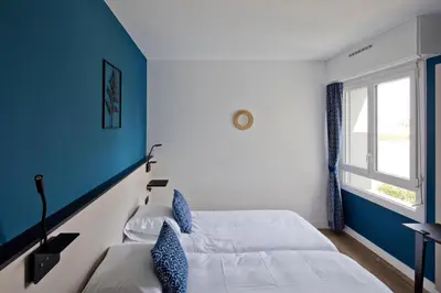 Un ou plusieurs lits dans un hébergement de l'établissement Hôtel Le Riccoty