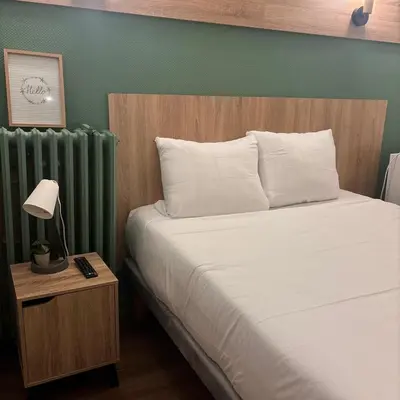 Un ou plusieurs lits dans un hébergement de l'établissement Central Hôtel