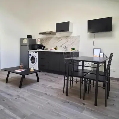Cuisine ou kitchenette dans l'établissement L'Oasis Fleurie