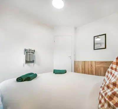 Un ou plusieurs lits dans un hébergement de l'établissement Bel appartement avec grande terrasse