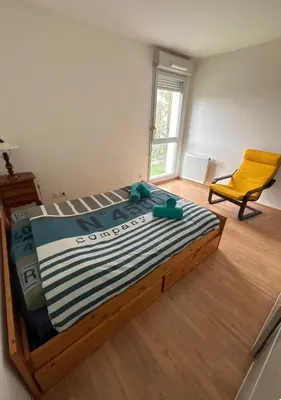 Un ou plusieurs lits dans un hébergement de l'établissement Un appartement dans un coin tranquille
