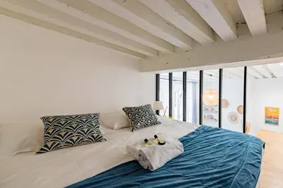 Un ou plusieurs lits dans un hébergement de l'établissement GuestReady - Modern Studio in The Heart of La Presqu'île