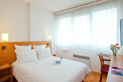 Un ou plusieurs lits dans un hébergement de l'établissement Séjours & Affaires Lyon Saint-Nicolas