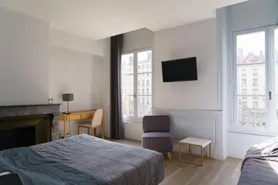 Un ou plusieurs lits dans un hébergement de l'établissement Hotel du Théatre