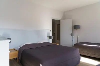 Un ou plusieurs lits dans un hébergement de l'établissement Hotel du Théatre