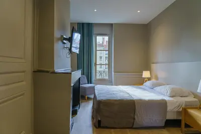 Un ou plusieurs lits dans un hébergement de l'établissement Hotel du Théatre