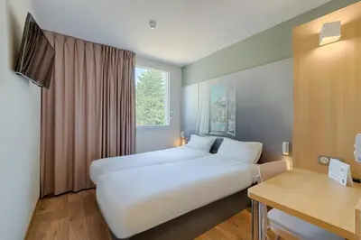 Un ou plusieurs lits dans un hébergement de l'établissement B&B HOTEL Lyon Centre Monplaisir