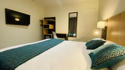 Un ou plusieurs lits dans un hébergement de l'établissement Hotel Martinez Grenay
