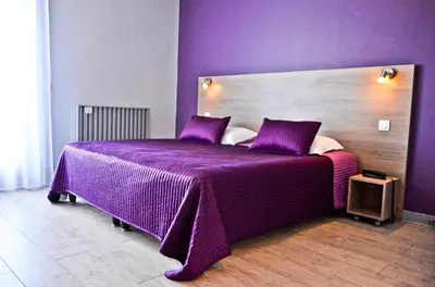 Un ou plusieurs lits dans un hébergement de l'établissement Hotel Le Comty