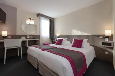 Un ou plusieurs lits dans un hébergement de l'établissement Kyriad Saint-Etienne Centre