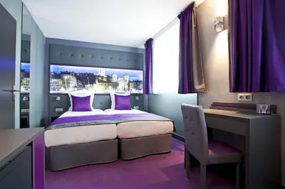 Un ou plusieurs lits dans un hébergement de l'établissement Hotel des Savoies Lyon Perrache
