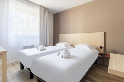 Un ou plusieurs lits dans un hébergement de l'établissement Appart'City Classic Lyon Part Dieu Garibaldi