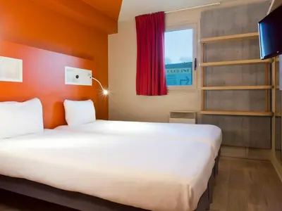 Un ou plusieurs lits dans un hébergement de l'établissement Ibis Budget Bourgoin Jallieu Centre