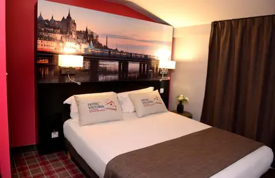 Un ou plusieurs lits dans un hébergement de l'établissement Hotel Victoria Lyon Perrache Confluence