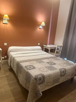 Un ou plusieurs lits dans un hébergement de l'établissement Hotel Azur