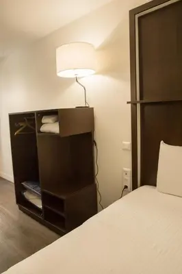 Un ou plusieurs lits dans un hébergement de l'établissement Kyriad Villefranche Sur Saone Porte du Beaujolais -Rénové-