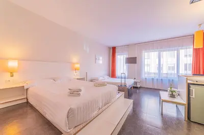 Un ou plusieurs lits dans un hébergement de l'établissement Residence Montempo Appart'Hôtel Lyon Cite Internationale