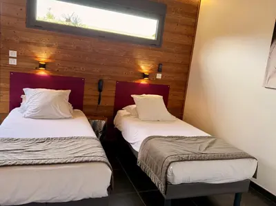 Un ou plusieurs lits dans un hébergement de l'établissement Bio-Motel
