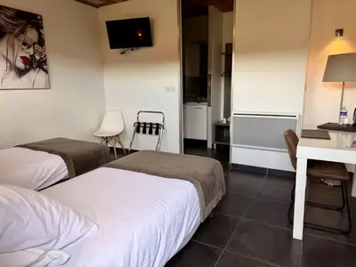 Un ou plusieurs lits dans un hébergement de l'établissement Bio-Motel