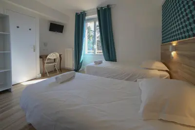 Un ou plusieurs lits dans un hébergement de l'établissement Cit'Hôtel La Résidence