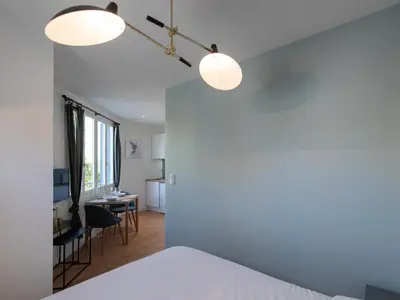 Un ou plusieurs lits dans un hébergement de l'établissement Appartements Le Berliet - Montplaisir