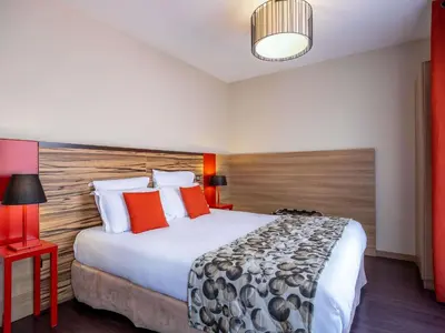 Un ou plusieurs lits dans un hébergement de l'établissement Aparthotel Adagio Lyon Patio Confluence