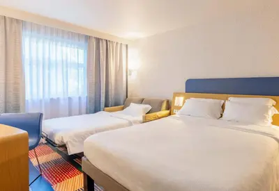 Un ou plusieurs lits dans un hébergement de l'établissement B&B HOTEL Lyon Nord 4 étoiles