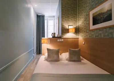 Un ou plusieurs lits dans un hébergement de l'établissement Hôtel du Dauphin