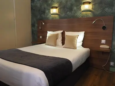 Un ou plusieurs lits dans un hébergement de l'établissement Hôtel du Dauphin