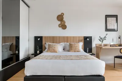 Un ou plusieurs lits dans un hébergement de l'établissement Appart hôtel Q7 Lodge Lyon 7
